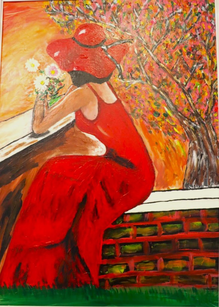Toile La dame en rouge, femme assise sur le seuil, robe rouge lumineuse.